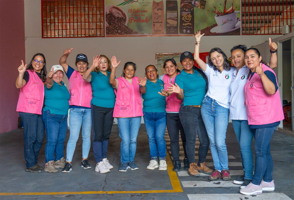 A group of women waving from a coffee workshop in Columbia