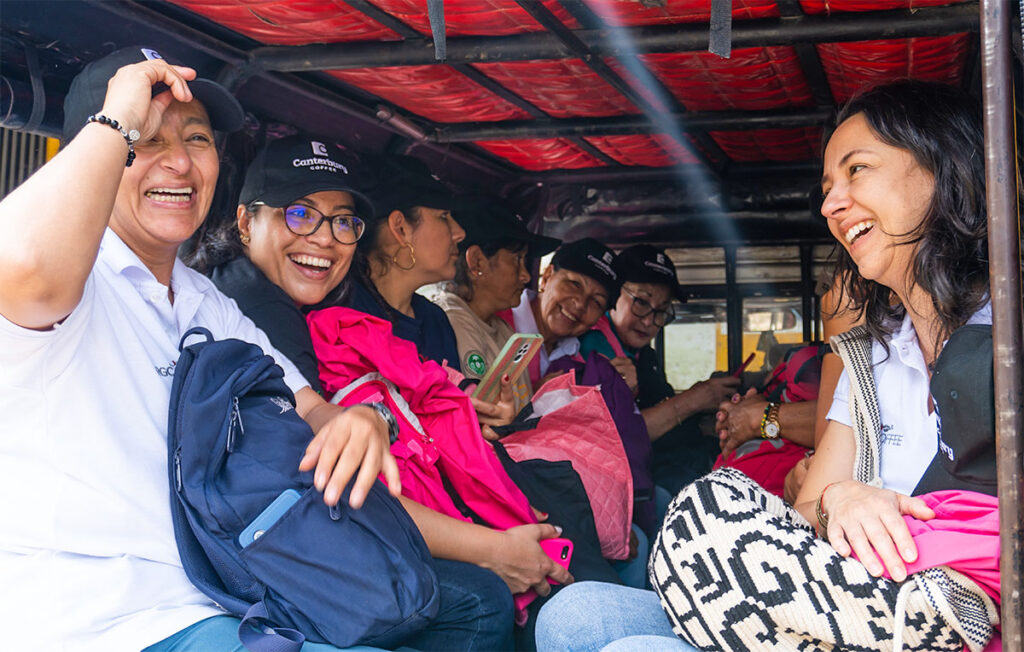 A group of women in the back of a pick up truck/taxi in Colombia